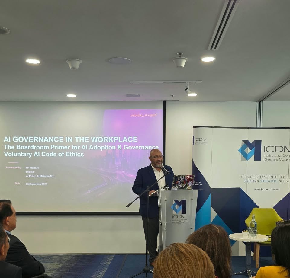 Reza Ali at the lectern presenting at the ICDM ASEAN Board Trends Report launch in Kuala Lumpur. The screen behind him reads AI Governance in the Workplace: The Boardroom Primer for AI Adoption and Governance, Voluntary AI Code of Ethics.